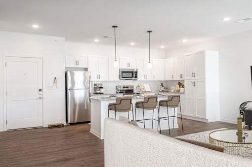 A modern kitchen with a dining table and chairs.