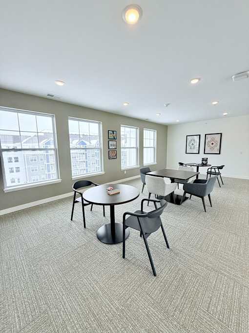 A conference room with a table and chairs.