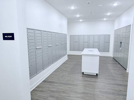 A mailbox room with a white mailbox on the floor.