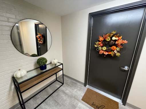A black door with a wreath on it.