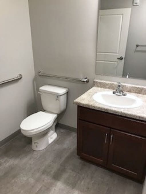 A white toilet sits next to a sink in a bathroom.