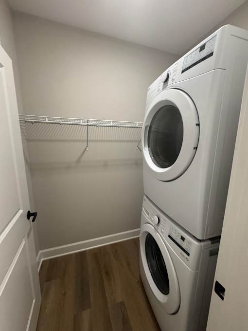 A white washing machine and dryer in a small laundry room.