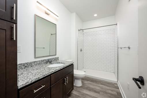 A bathroom with a white sink and a white toilet.