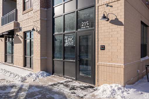 The building has a glass door with a sign that says LNC.