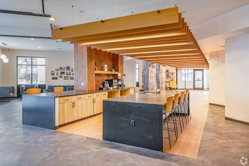 A modern kitchen with wooden beams and a black counter.