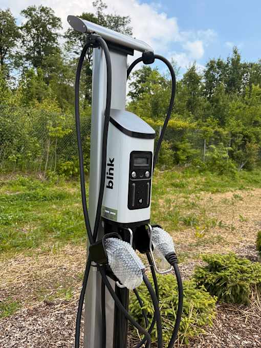 A Blink charging station is set up outdoors.