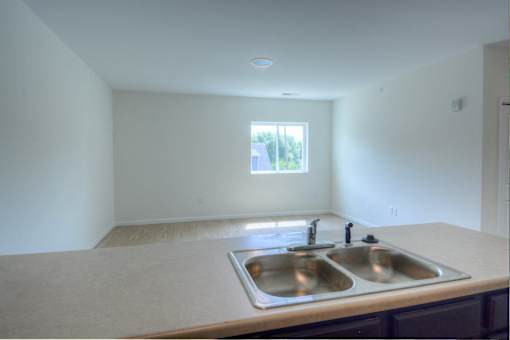 A kitchen with a double sink and a window.at Union at 16th, Indianapolis