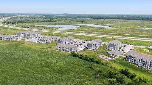 A bird's eye view of a residential area with houses and a playground. at Union at the Loop, Lawrence, Kansas