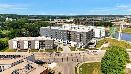 Aerial view of modern apartment buildings along riverfront 1 at Union at Rivers Edge Apartments, Des Moines, IA