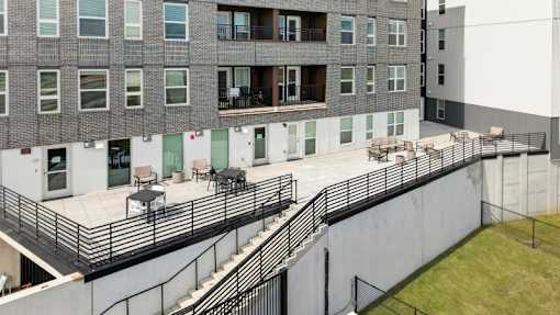 Outdoor courtyard terrace with seating areas at Union at Rivers Edge Apartments, Iowa