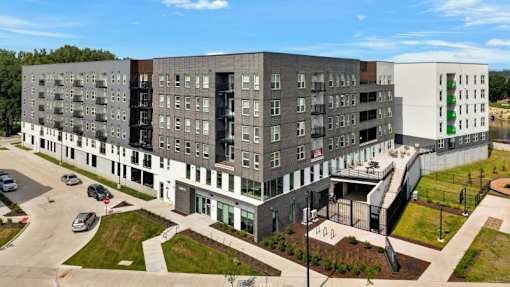 Modern multistory apartment building exterior with parking 1 at Union at Rivers Edge Apartments, Iowa, 50315