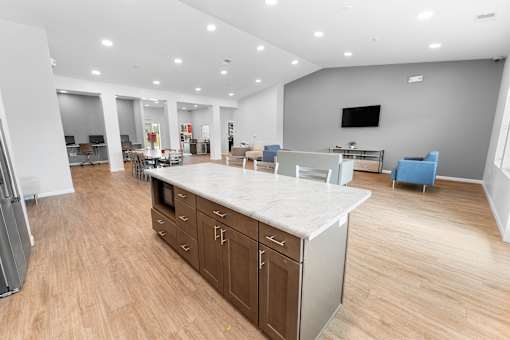 A modern kitchen with a large island and wooden floors.at Union at North Crossing, Iowa, 50703