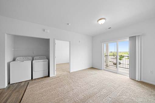 A laundry room with a washer and dryer. at Union at the Loop, Kansas, 66046