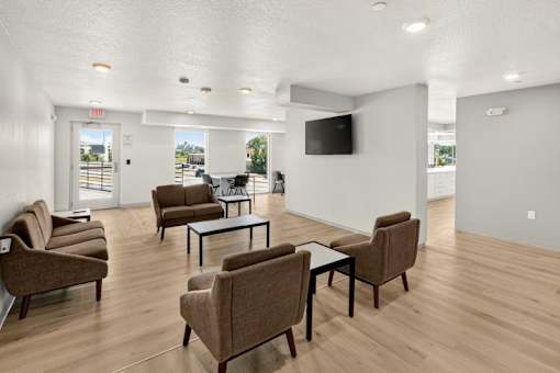 Community lounge with comfortable seating and television at Union at Rivers Edge Apartments, Des Moines