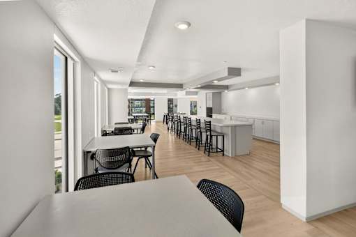Community clubhouse with kitchen and dining area at Union at Rivers Edge Apartments, Des Moines, IA, 50315