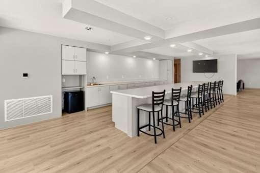 Community room with full kitchen and bar seating at Union at Rivers Edge Apartments, Des Moines, IA