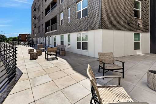 Rooftop terrace with wicker lounge seating at Union at Rivers Edge Apartments, Iowa, 50315