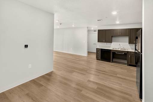 Open concept living space with modern kitchen at Union at Rivers Edge Apartments, Iowa