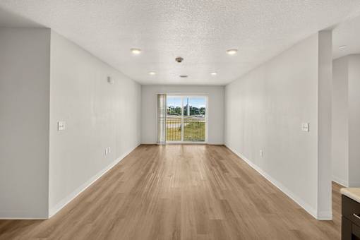 Spacious living room with wood style flooring at Union at Rivers Edge Apartments, Des Moines, IA