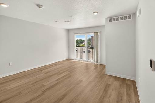Spacious living room with wood style flooring 1 at Union at Rivers Edge Apartments, Des Moines, IA, 50315