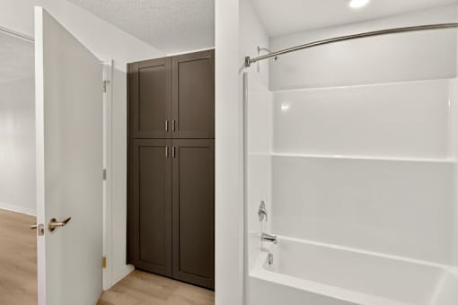 Bathroom with built in storage cabinets at Union at Rivers Edge Apartments, Des Moines, Iowa