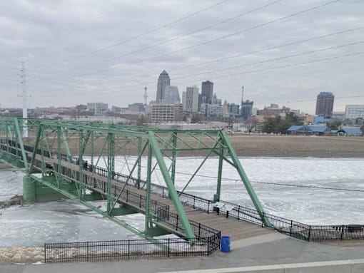 A bridge over a river with a city skyline in the background near Union at Rivers Edge Apartments, Des Moines