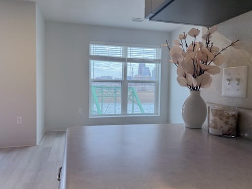 A kitchen with a table, vase, and candle at Union at Rivers Edge Apartments, Des Moines