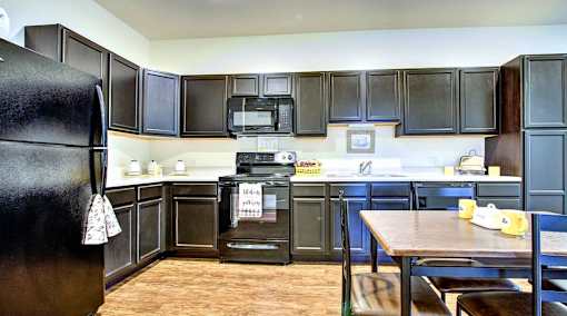 A kitchen with black appliances and cabinets.at Union at Crescent, Bloomington, IN 47404  