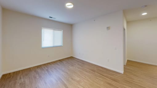 A room with a window and wooden flooring at Union at 16th, Indianapolis Indiana