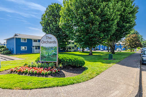A blue building with a sign that says The Orchards.