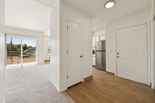 A white interior with a kitchen in the background.