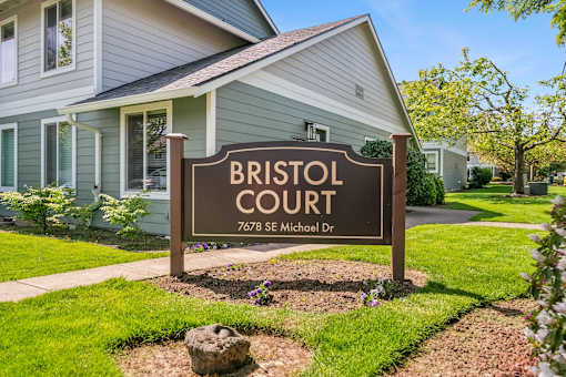A sign that says Bristol Court in front of a house.