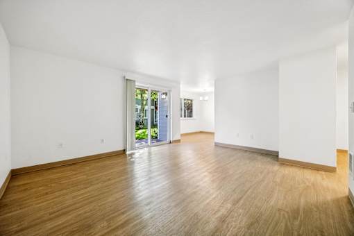 A room with wooden floors and white walls.