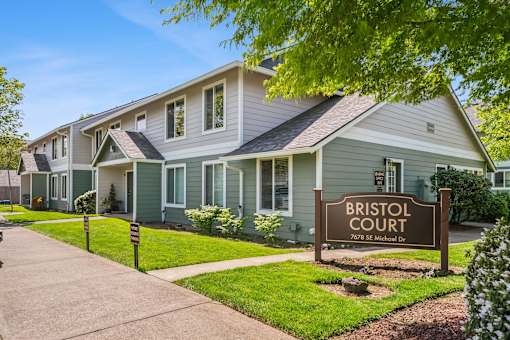 A building with a sign that says Bristol Court in front of it.