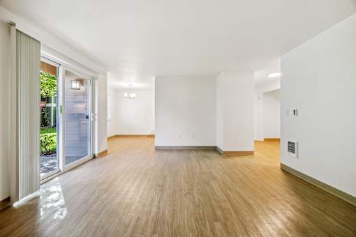 A room with wooden floors and white walls.