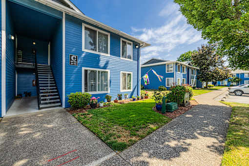 A blue building with a red line on the sidewalk.