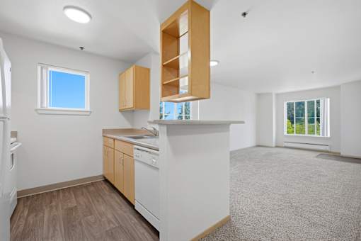 A kitchen with white appliances and wooden cabinets.