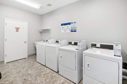 A laundry room with washers and dryers.