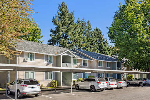A row of cars parked in front of a building.