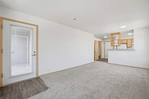 A room with white walls and a carpeted floor.