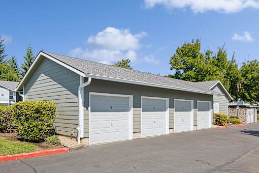 A two-car garage with a grey roof and white doors.