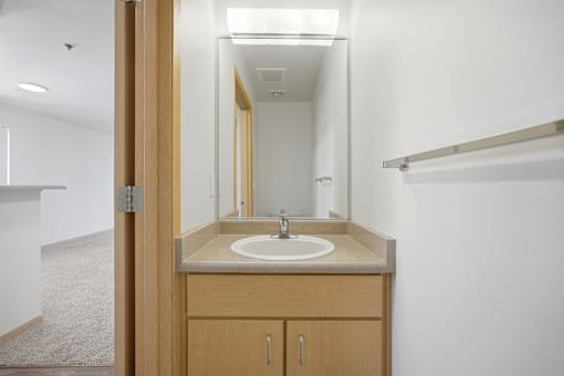 A bathroom with a sink and mirror.