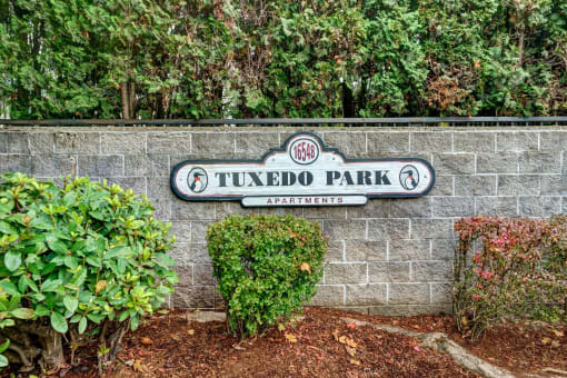 a sign for tudor park on a brick wall