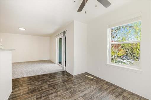 A room with a window and a ceiling fan.