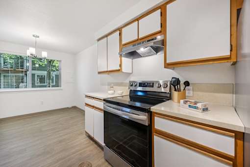 A modern kitchen with a stove top oven and a microwave.
