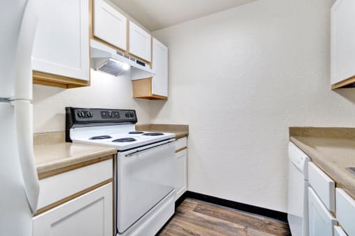 a kitchen with white appliances and white cabinets