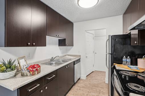 A kitchen with brown cabinets and a black stove top.