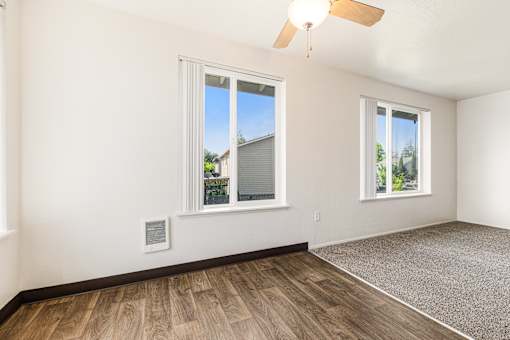 A room with a window and a ceiling fan.