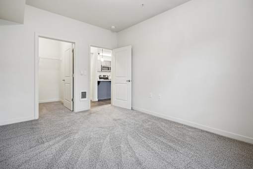 A room with a carpeted floor and white walls.