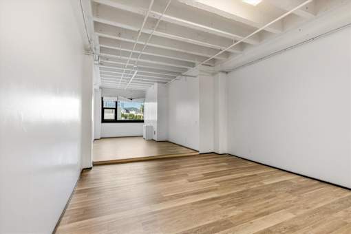 A room with wooden floors and white walls.